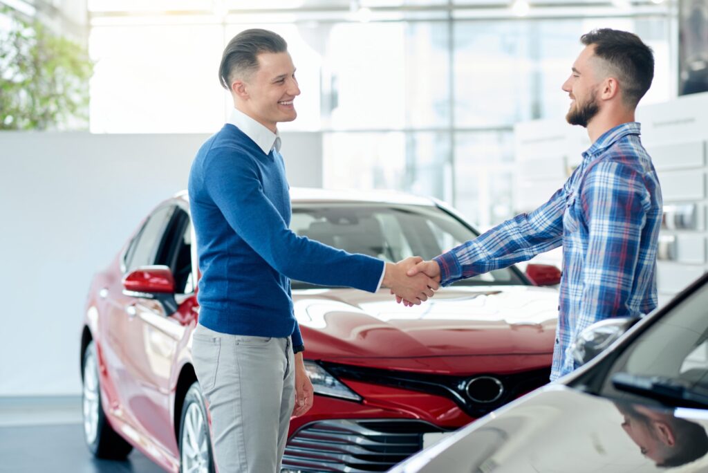 Car seller and customer handshake