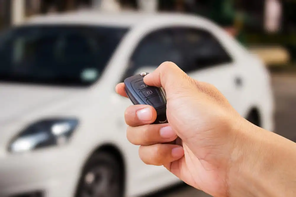 Men's Hand Presses On The Car Remote Control